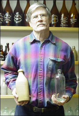 Franklin Wisconsin antique bottle collector finding Wisconsin beers fascination and great fun Sid holding 2 Wisconsin Antique beer bottles